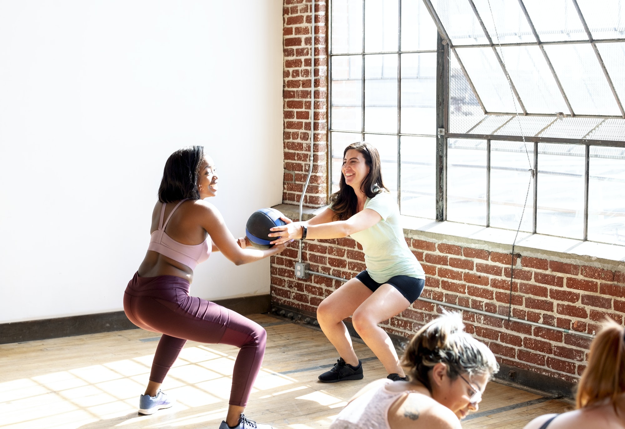 Women doing squats in fitness class